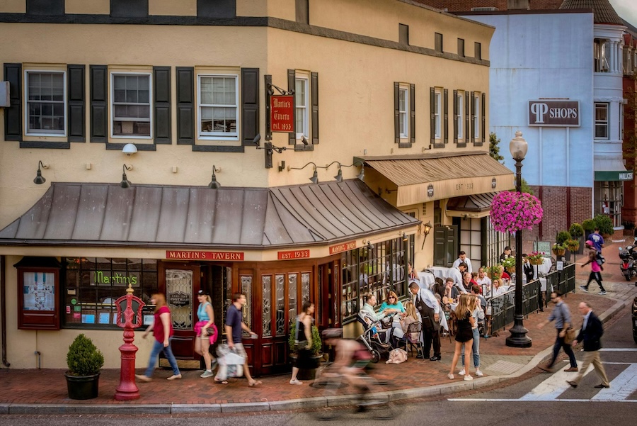 Outside of the historic Martin's Tavern in Georgetown on a bright day with pedestrians walking by.